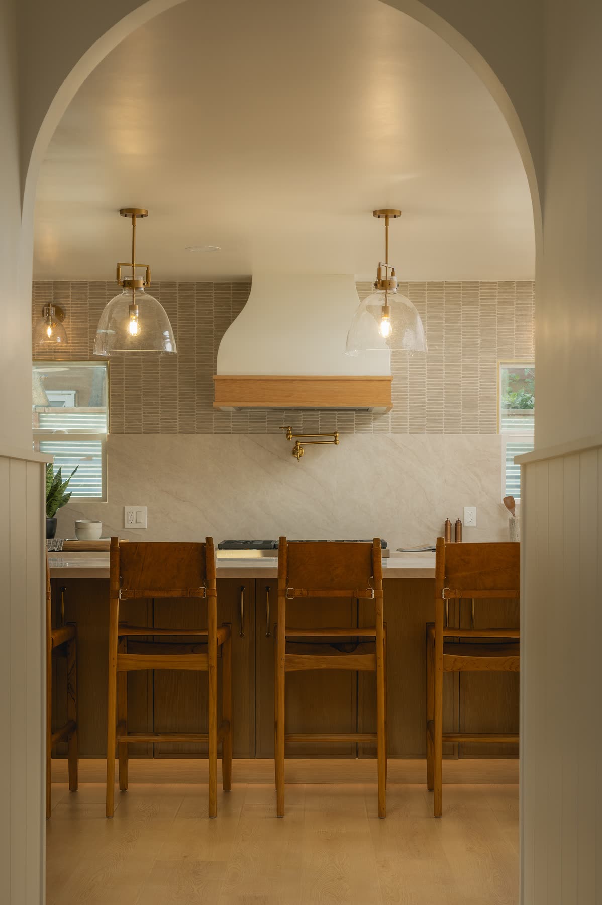 Kitchen seen through an arched opening