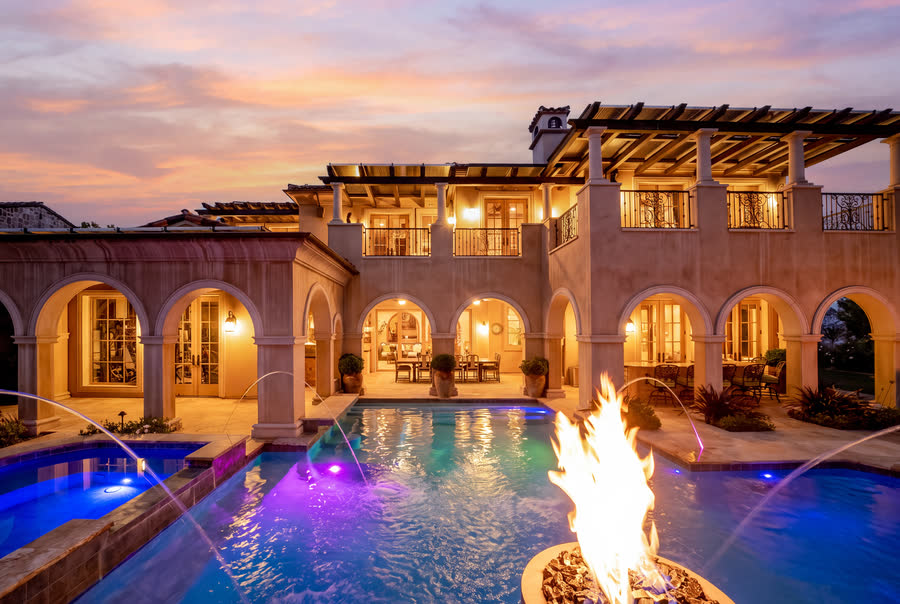 Loggia and pool at dusk, fire bowl lit